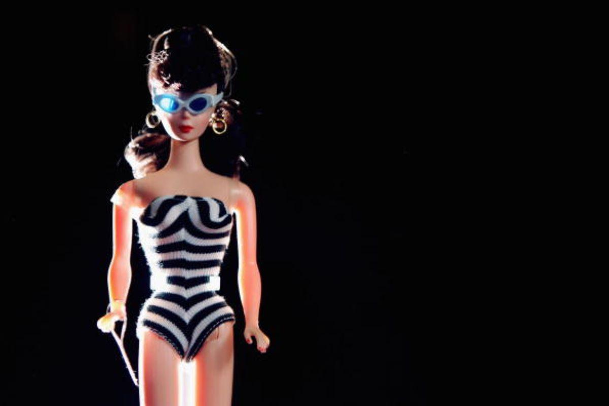 Vintage 1959 Barbie in striped swimsuit and sunglasses