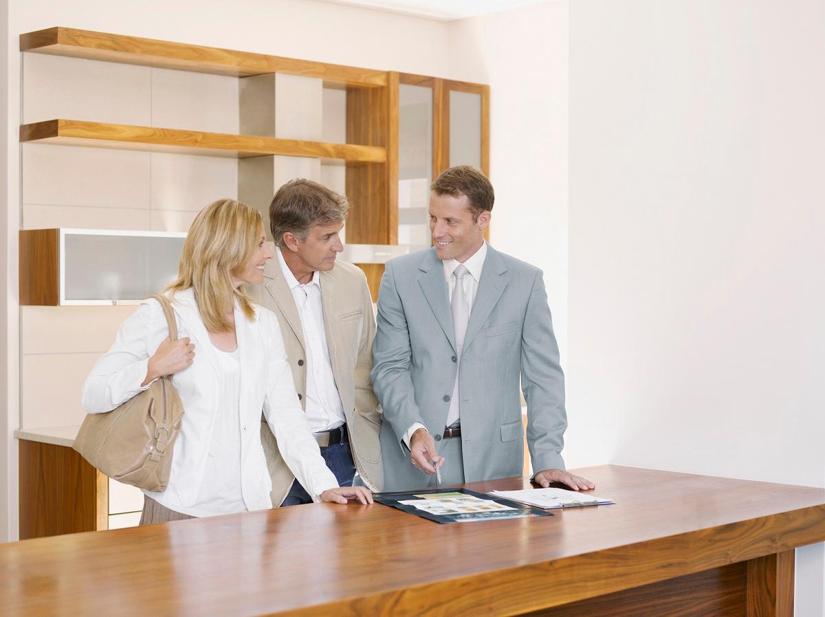 Couple talking with real estate agent