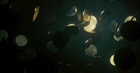 Coins sinking in water