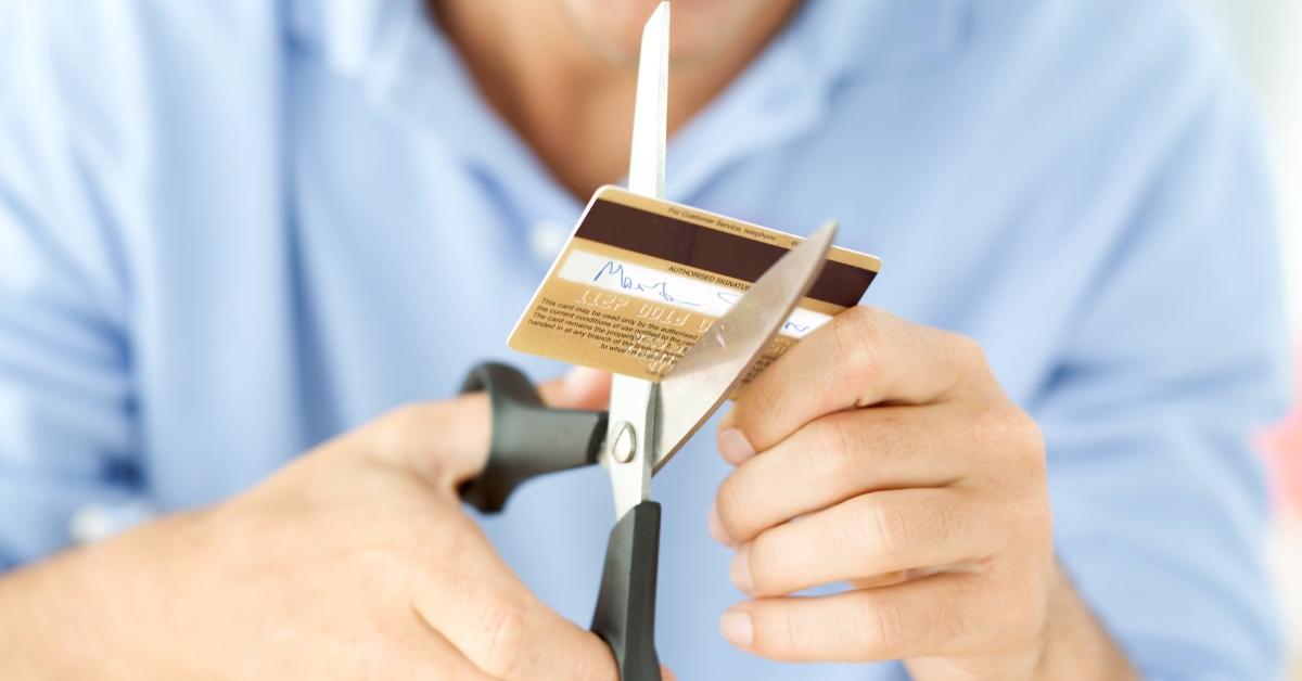 A person cutting up a credit card