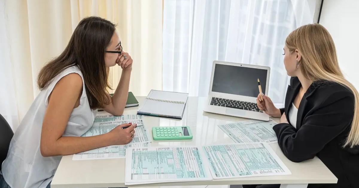 A woman discusses her taxes with her tax preparer.