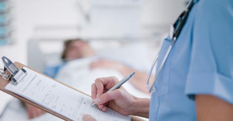 A nurse filling out medical paperwork