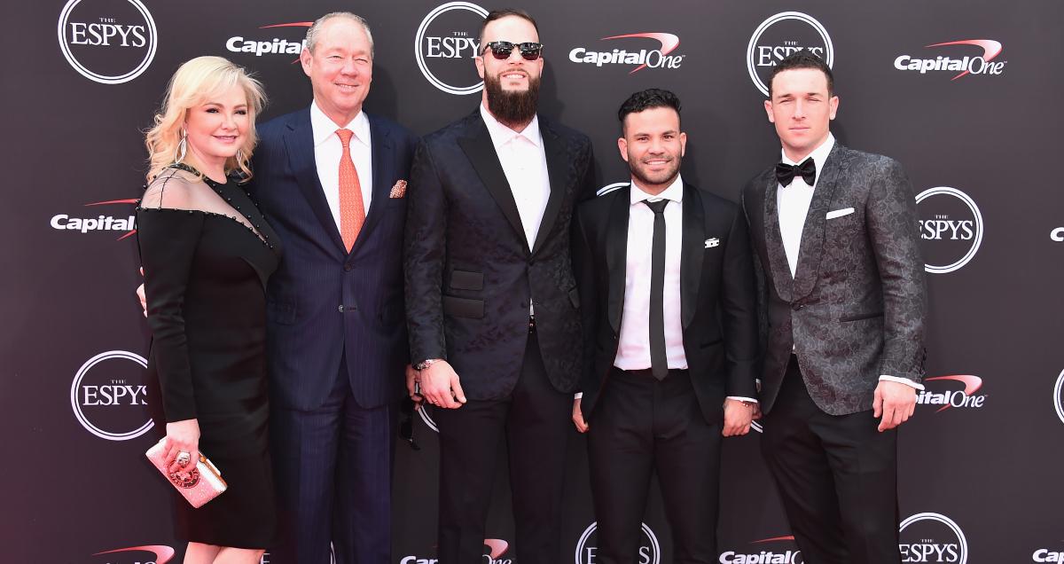 Jim Crane posing in a group at an event