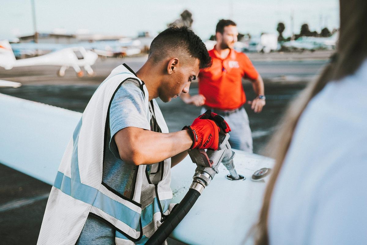 A person refueling a plane