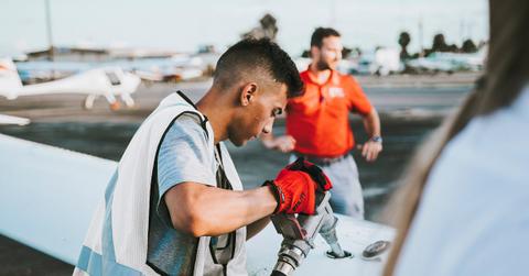 A person refueling a plane