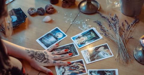 A tarot card reader looking at cards