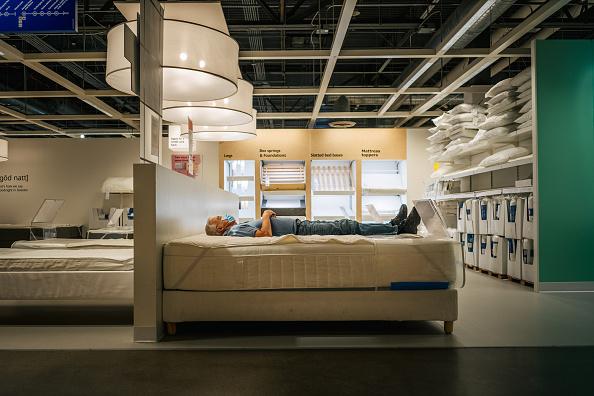 A man trying out a bed in IKEA