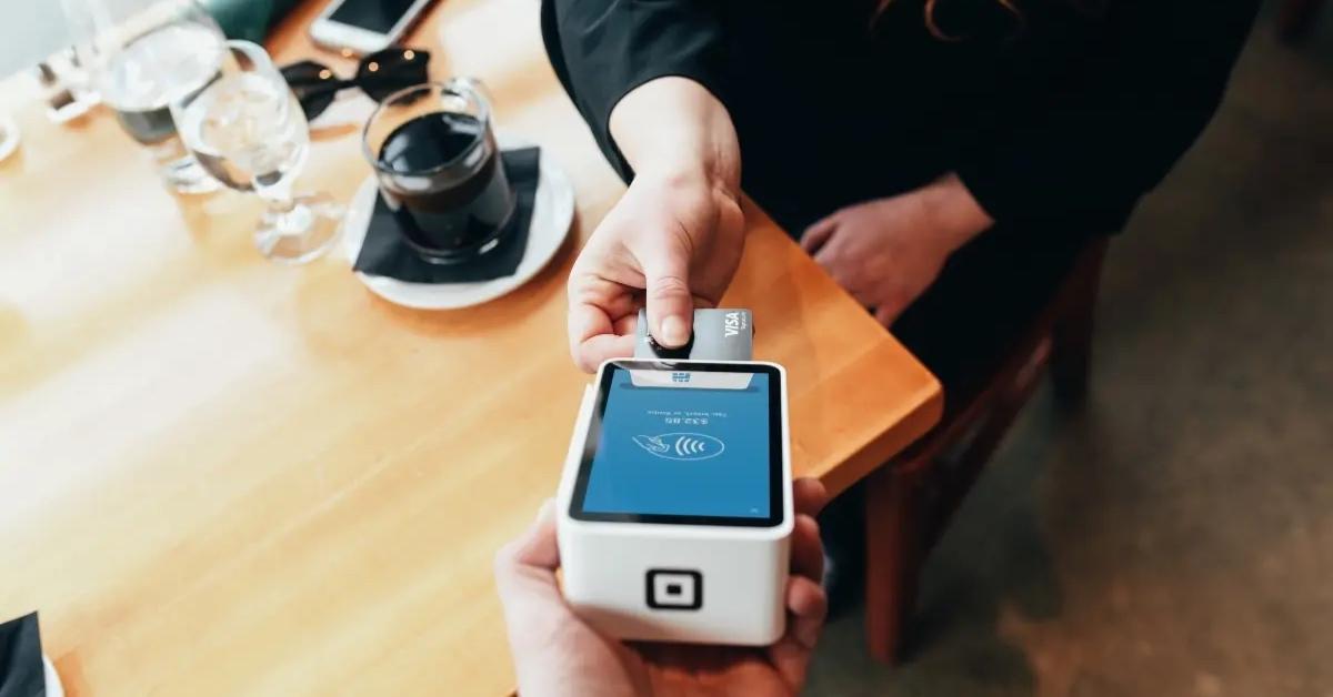 A customer at a restaurant pays with a credit card.