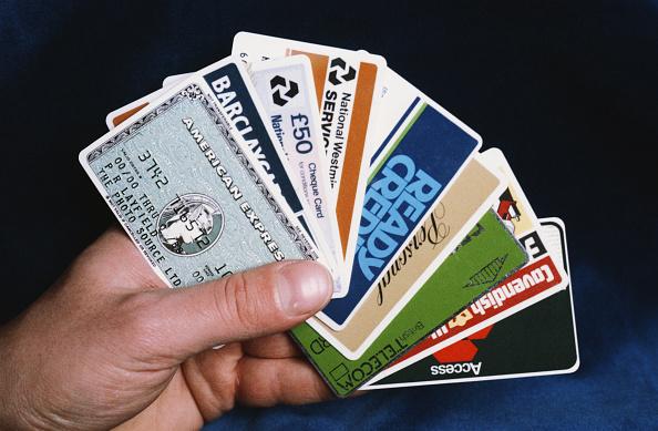 A person holding credit cards