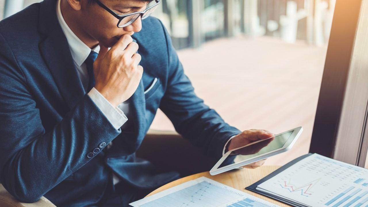 A man looking at economic data