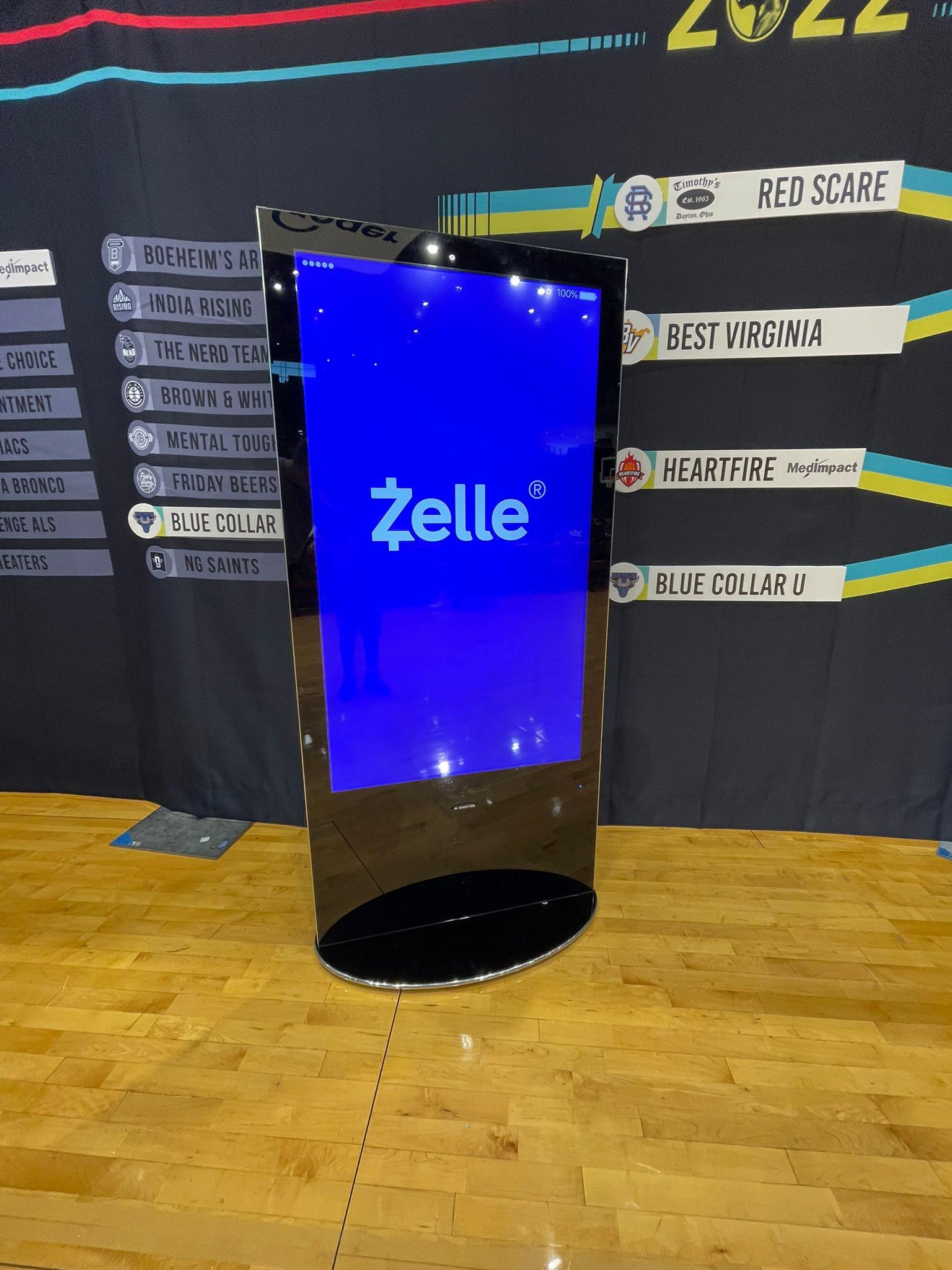 The Zelle logo on a large phone display screen