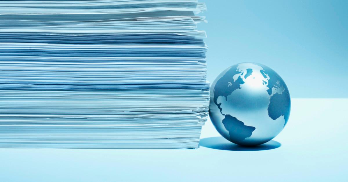 stack of paper with globe