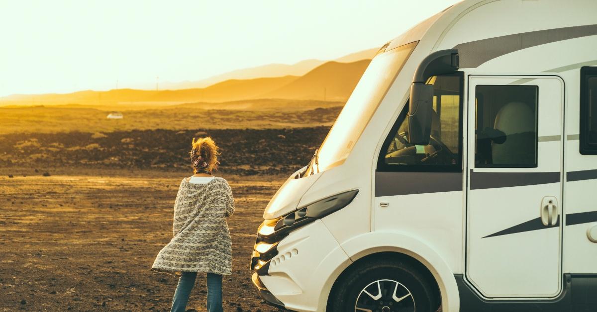 A woman standing by an RV