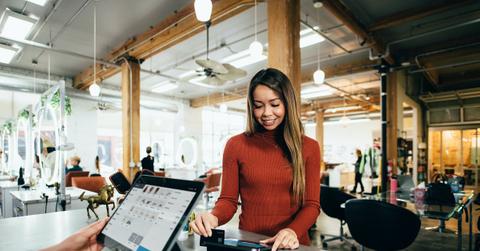 A person using a card to pay at a cashier