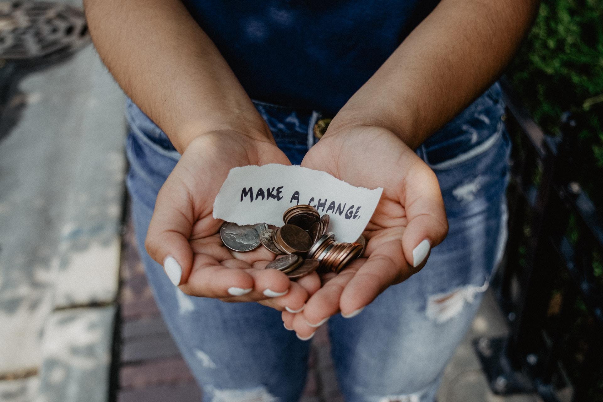 Change for Change still image woman holding coin make a change 