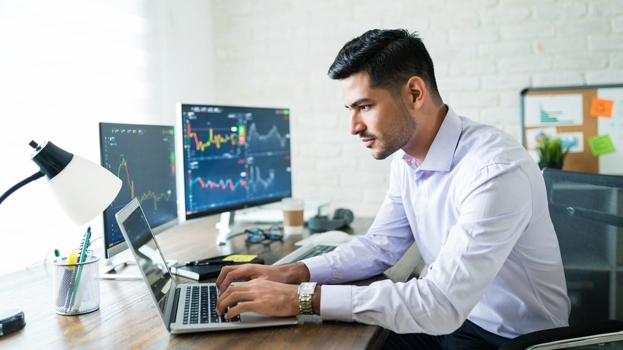 Man looking at stock market data