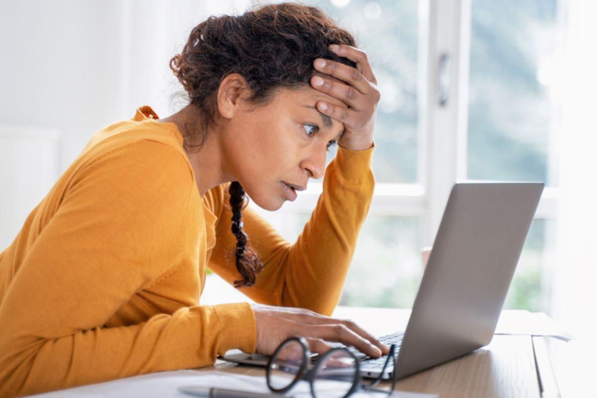 Woman is stressed out looking at how much she owes in taxes