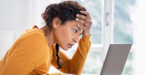 Woman is stressed out looking at how much she owes in taxes
