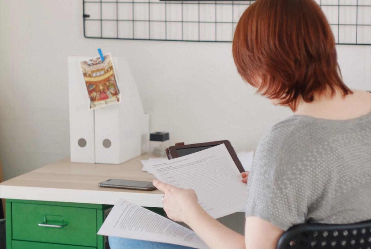 A woman reading lease paperwork