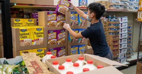 A person stocking groceries at a store