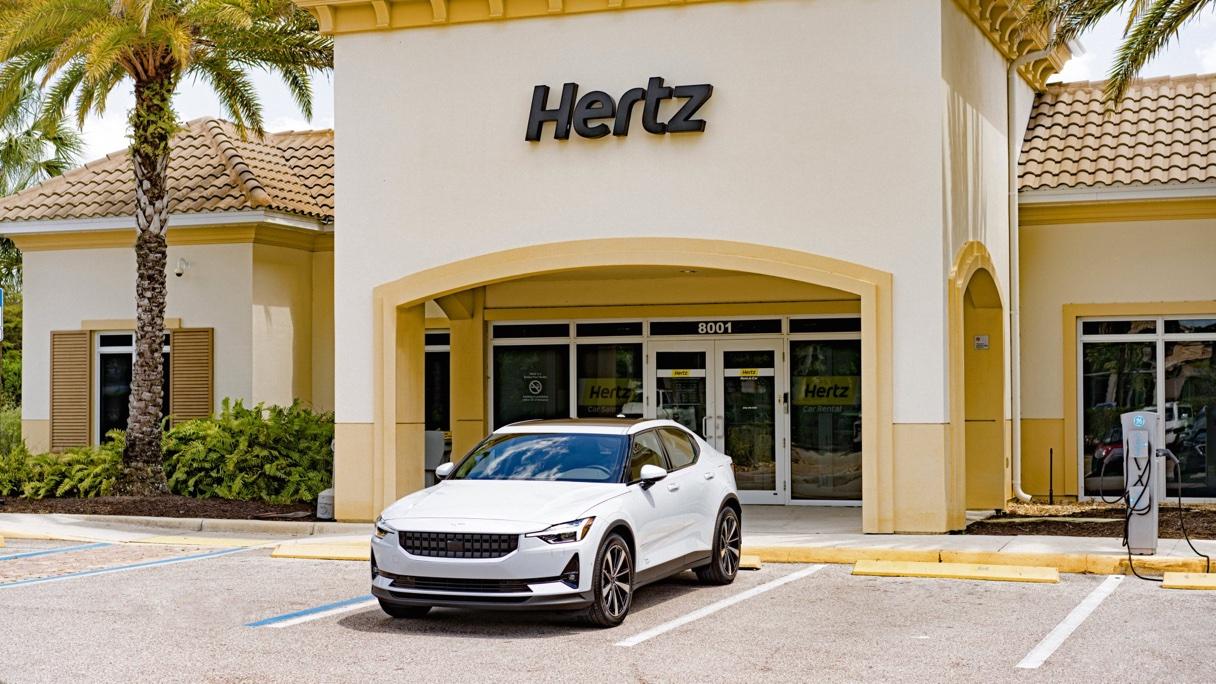 A Polestar car outside of a Hertz rental building