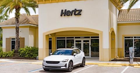 A Polestar car outside of a Hertz rental building