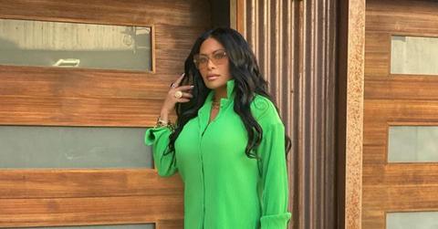 Jen Shah posing in green outfit
