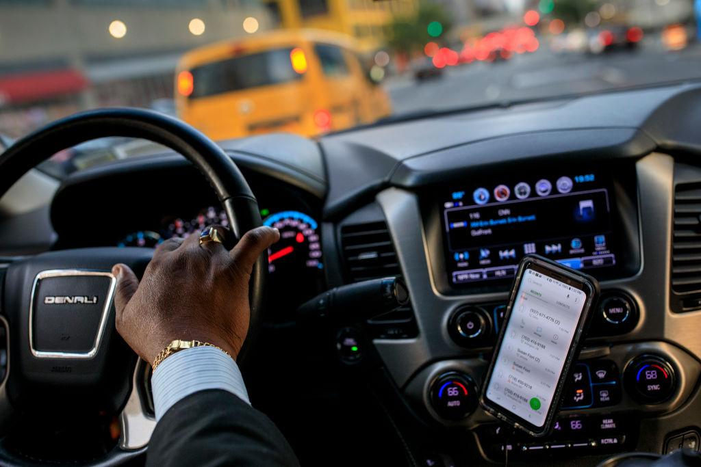 A man using a driving app to make money