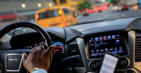 A man using a driving app to make money