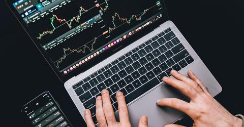 Crypto prices displayed on a laptop and smartphone