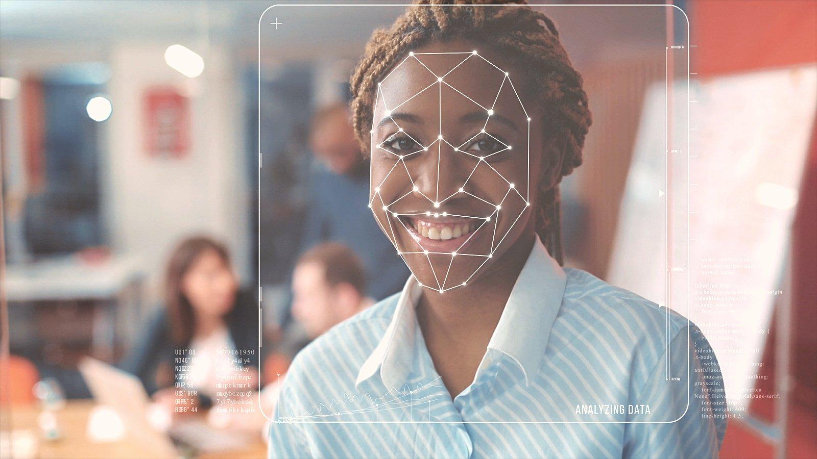 A woman with markings for deepfake technology on her face