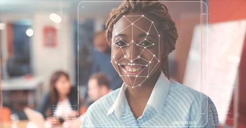 A woman with markings for deepfake technology on her face