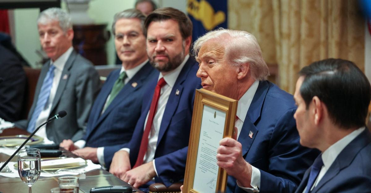 trump shows document during argentina meeting as J.D. Vance looks on