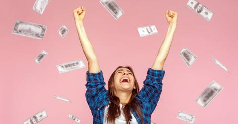 A woman celebrating saving money