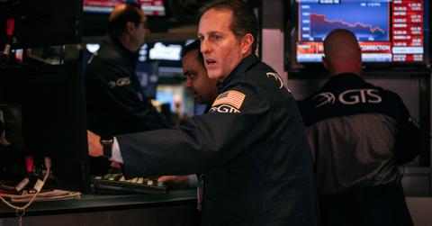 Trader looks at stock quotes as markets crash