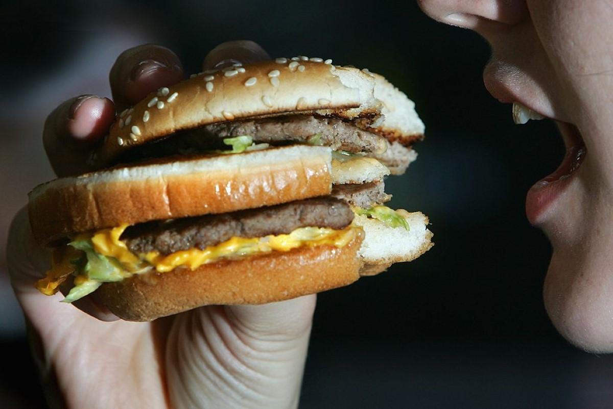 A woman about to take a bite out of a Big Mac