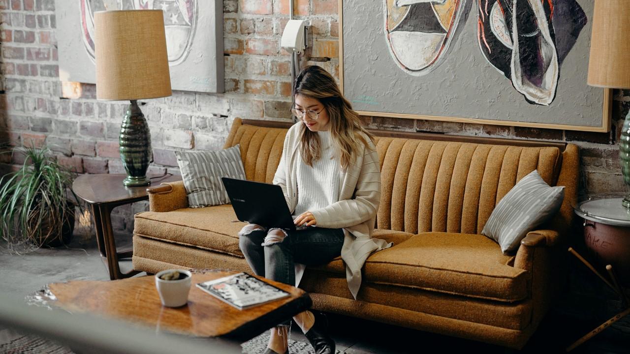 woman in her home researching on computer