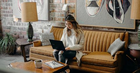 woman in her home researching on computer