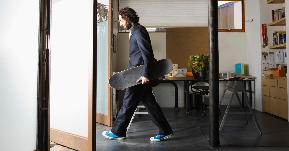 A man leaving work with his skateboard