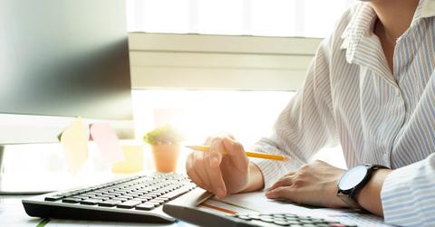 Businessperson calculating investment sheet statement