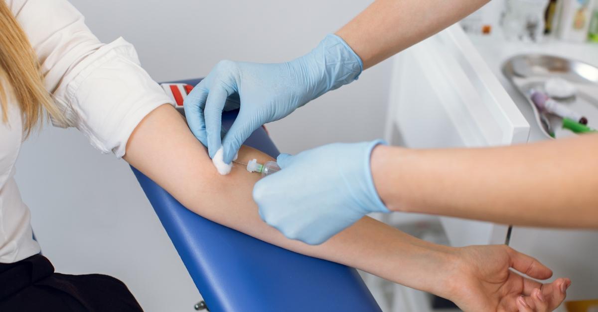 A phlebotomist preparing to draw blood.