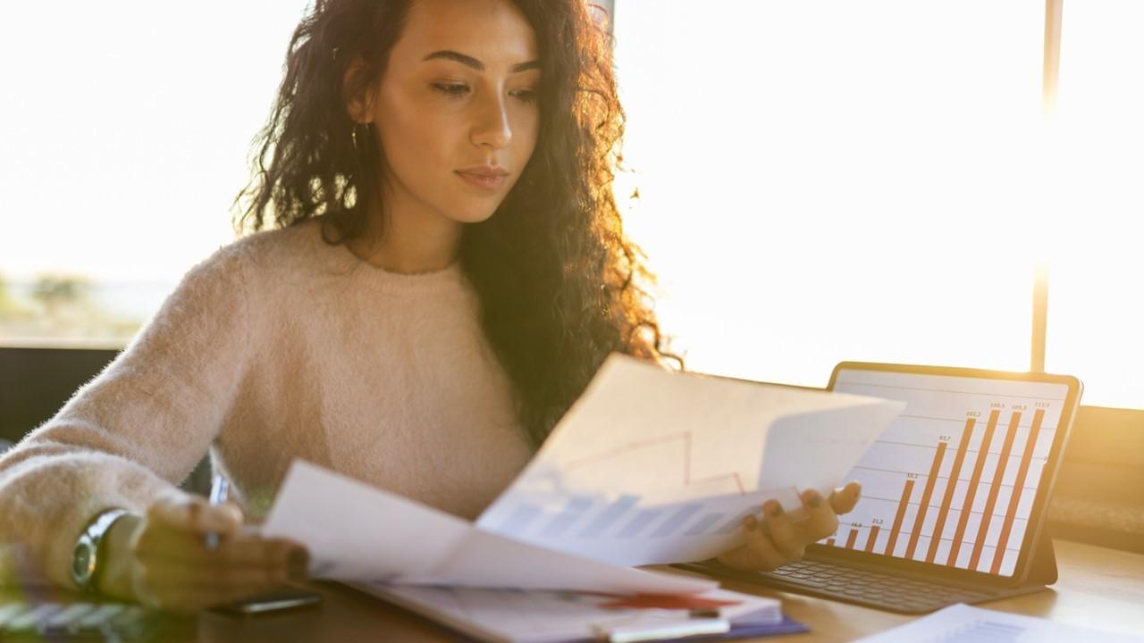 Woman looking at dividend yield stock data