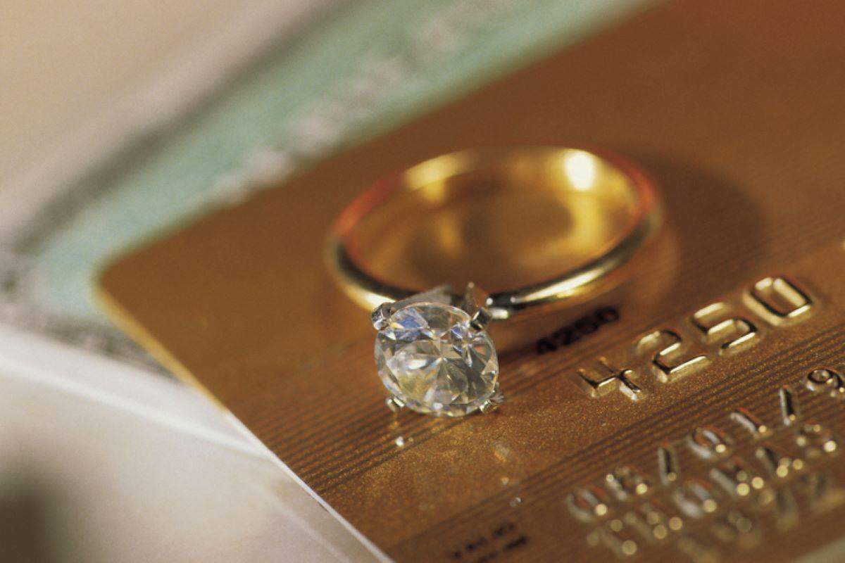 Engagement ring sitting atop a credit card