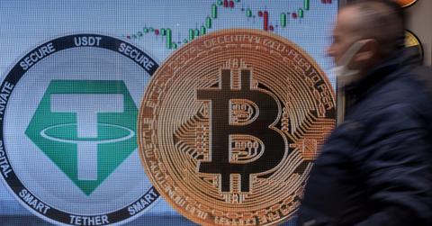 A man walks by a Bitcoin sign