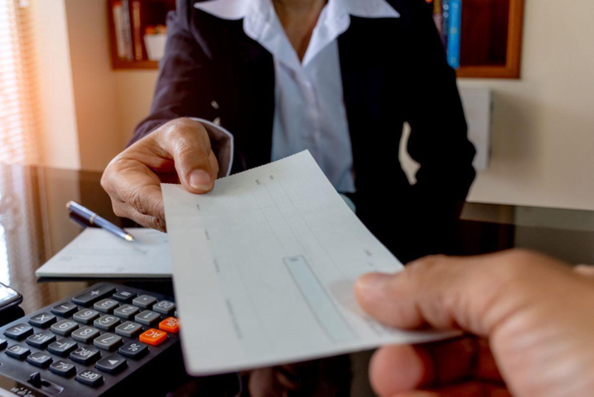 A banker handing over a cashier's check