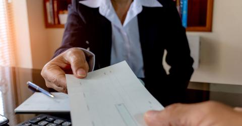A banker handing over a cashier's check