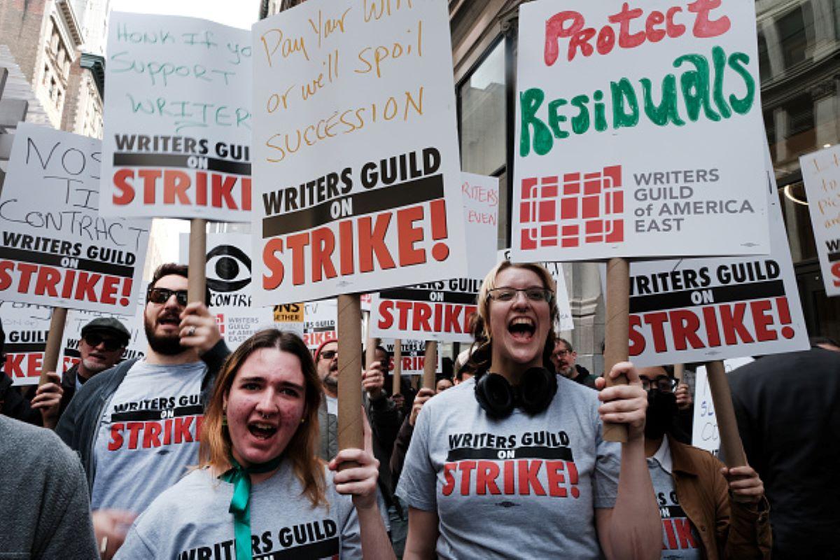 TV writers on strike holding signs