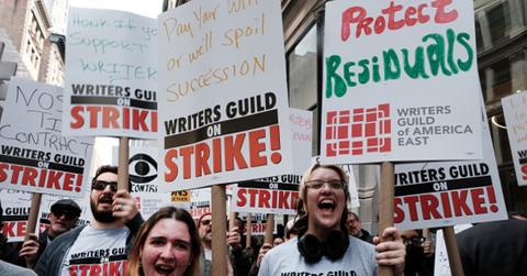 TV writers on strike holding signs