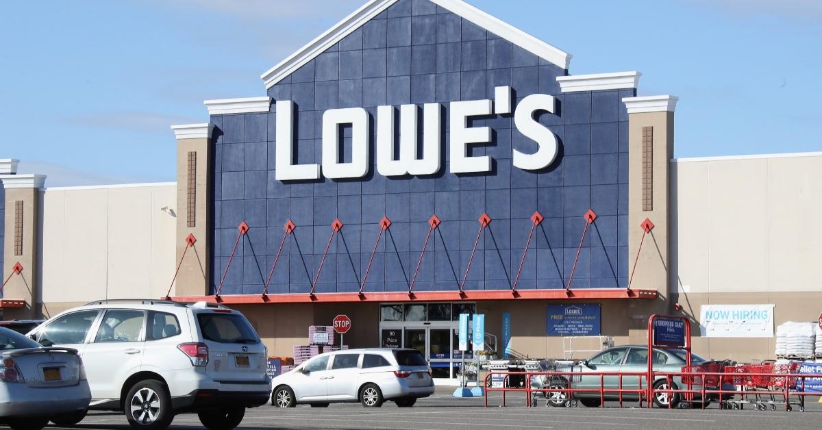 Lowe's store front and parking lot with cars.