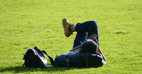 A summer student relaxing on the grass